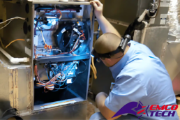 Service Technician Performing Furnace Inspection - EMCO Tech Heating and Cooling. HVAC Contractors Near You Service Technician Performing Furnace Inspection