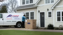 AC replacement in Horsham PA — EMCO Tech technician installing new air conditioner