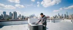 Commercial rooftop AC unit being inspected for problems in Philadelphia, PA