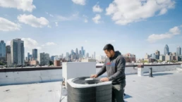 Commercial rooftop AC unit being inspected for problems in Philadelphia, PA