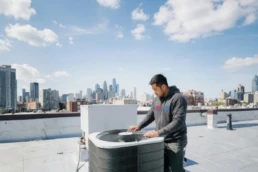Commercial rooftop AC unit being inspected for problems in Philadelphia, PA