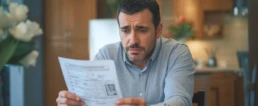 Why Running Your AC Costs So Much - Homeowner Looking at His Bill - EMCO Tech