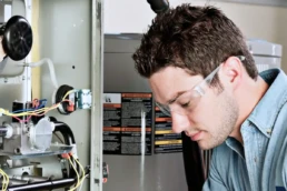 Fixing Your Furnace Before it Completely Malfunctions - EMCO Tech Heating & Cooling Technician Repairs Furnace