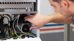 Is It Time for a New Heating System - EMCO Tech Technician Repairing Heater in Philadelphia