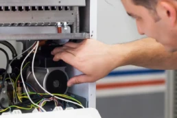 Is It Time for a New Heating System - EMCO Tech Technician Repairing Heater in Philadelphia