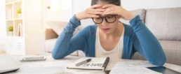 5 Proven Tips to Lower Your AC Bill in Summer - Woman is looking at her electric bill