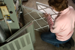 Homeowner Replacing Furnace Heater Air Filters - EMCO Tech in West Chester
