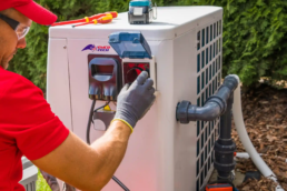 HVAC Repair Technician Working on AC Unit in Delaware County