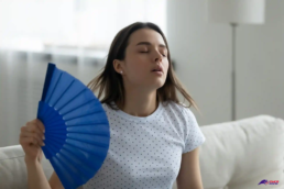 How to Prevent AC Breakdowns This Summer - woman with fan and no AC - EMCO Tech Heating and Cooling. HVAC Contractors Near You How to Prevent Ac Breakdowns This Summer - Woman with Fan and No Ac
