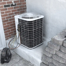 Spring AC Tune-Up and Maintenance - air conditioning unit with freon gages and tool bag next to it