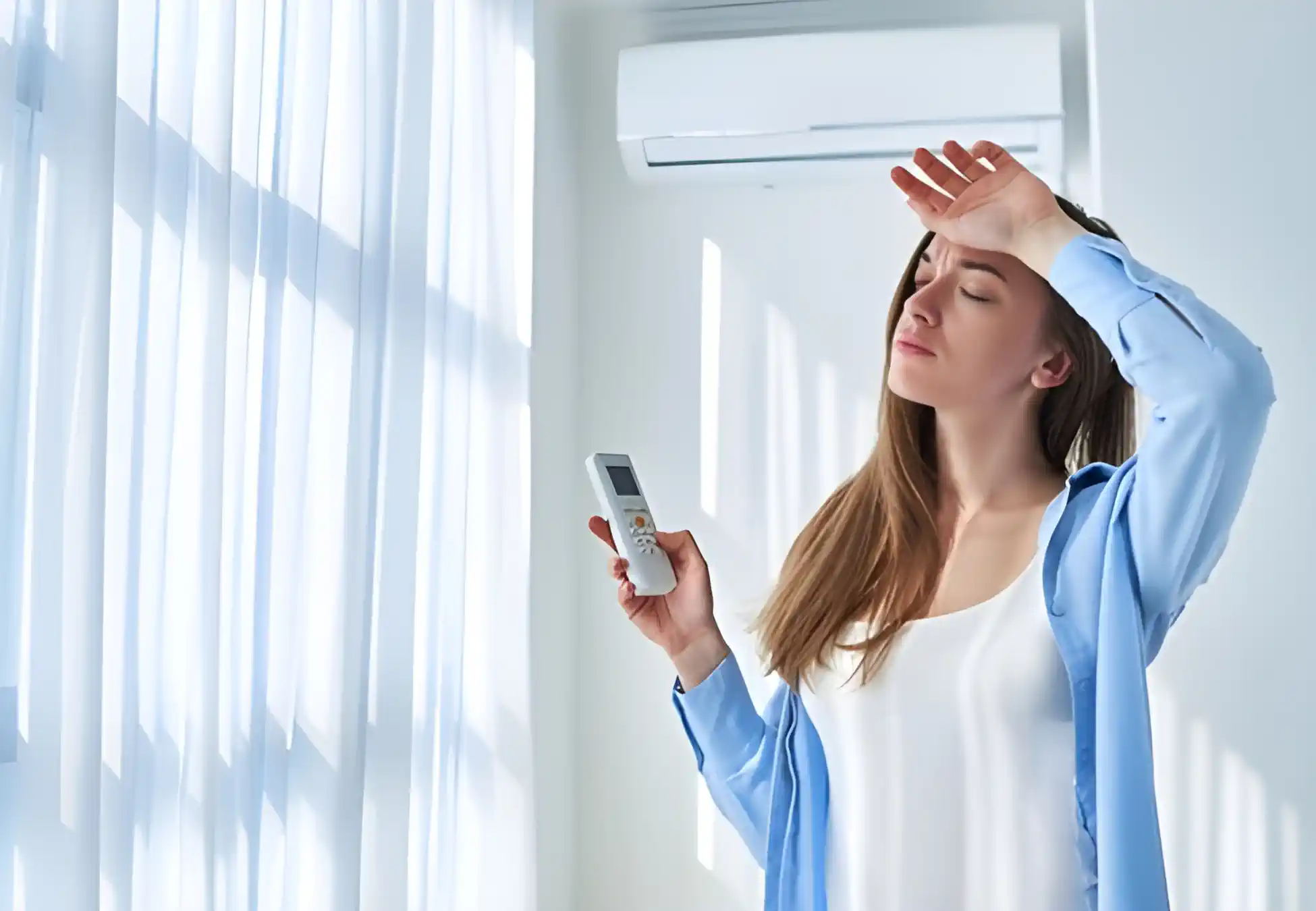 AC Isnt Blowing Cold Air What to Do Next - Woman with AC remote getting hot because its not working