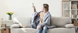 Ductless Minisplit System - Indoor Air Handler - Woman with remote for ductless unit - EMCO Tech Ductless Mini-Split Installation