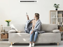 Ductless Minisplit System - Indoor Air Handler - Woman with remote for ductless unit - EMCO Tech Ductless Mini-Split Installation