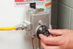 Water Heater Repair Services by EMCO Tech - Technician Adjusting Water Temperature