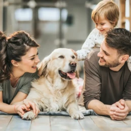 Happy Family at home- Family enjoying their comfortable home in Philadelphia with their dog after gas furnace repair by EMCO Tech