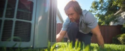 Homeowner checking outdoor AC condenser before a summer heat wave in Bucks County, PA - EMCO Tech