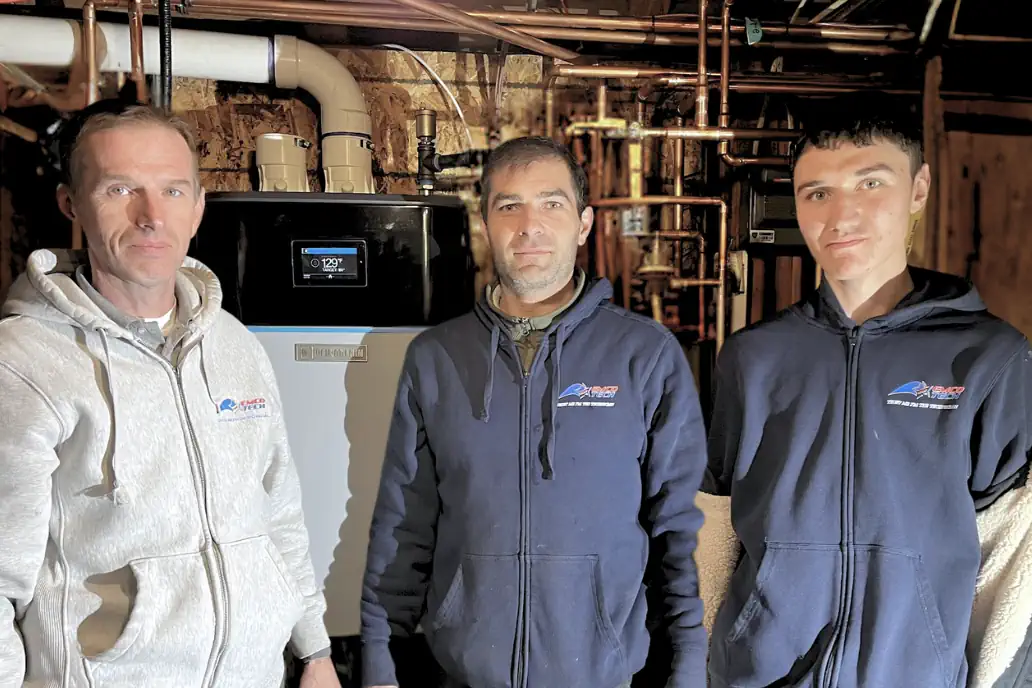 EMCO Tech technicians Dimitri and Alex with supervisor Serge after completing a high-efficiency multi-zone tankless boiler installation